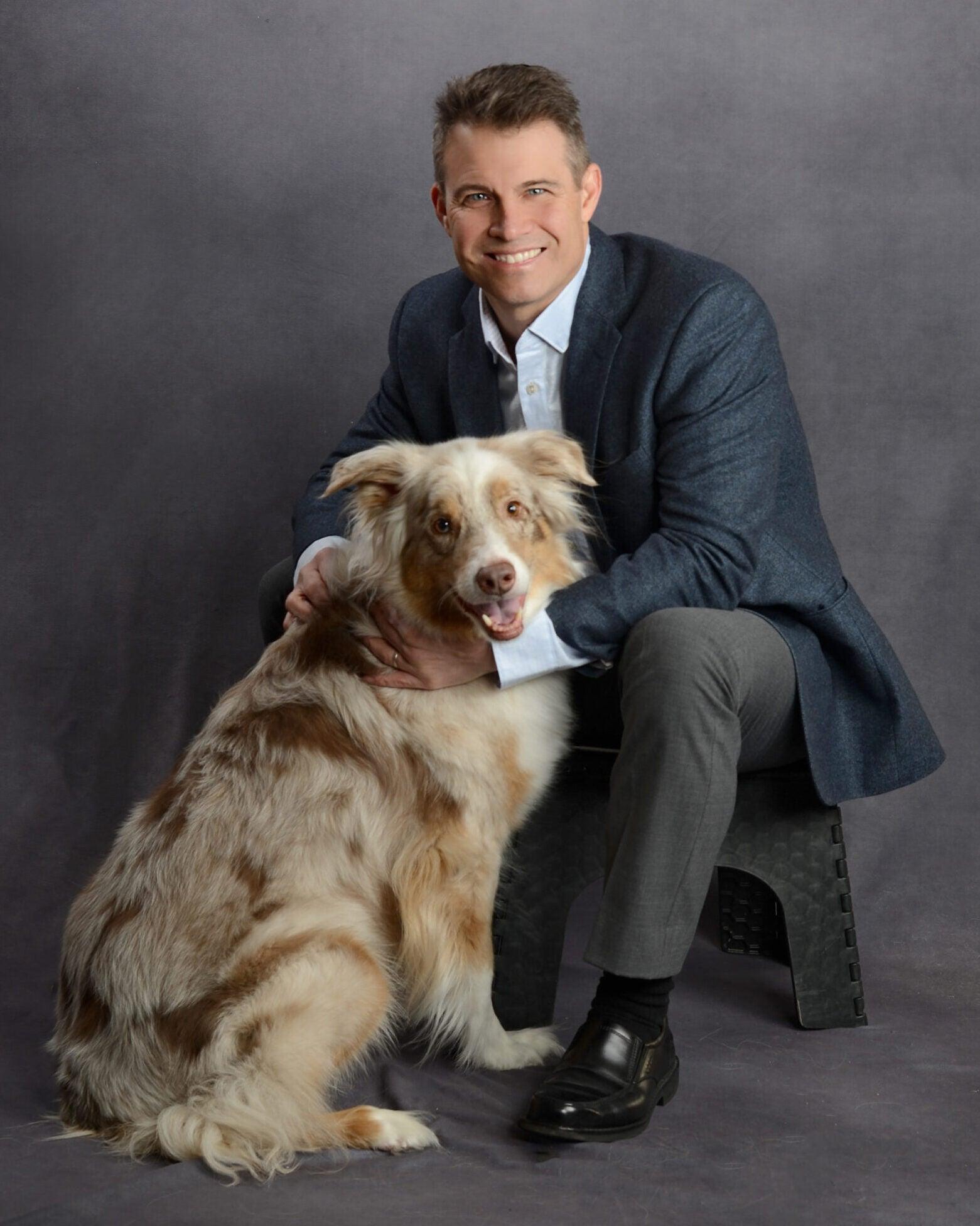 Veterinarian sits with his dog