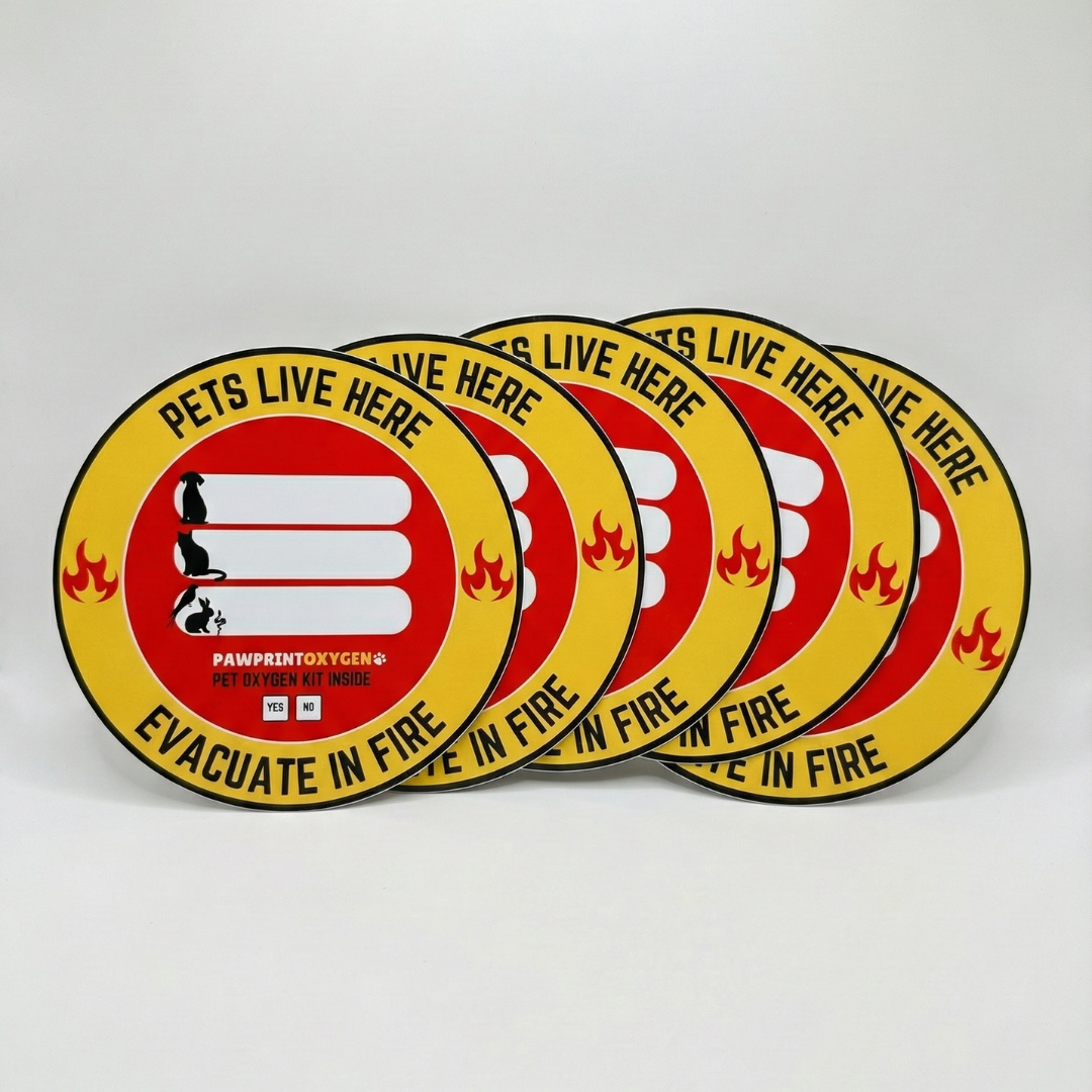 Round pet rescue window stickers reading ‘Pets Live Here Evacuate in Fire,’ showing icons of a dog, cat, and small animal, designed to alert firefighters that pets are inside the home during a fire emergency.
