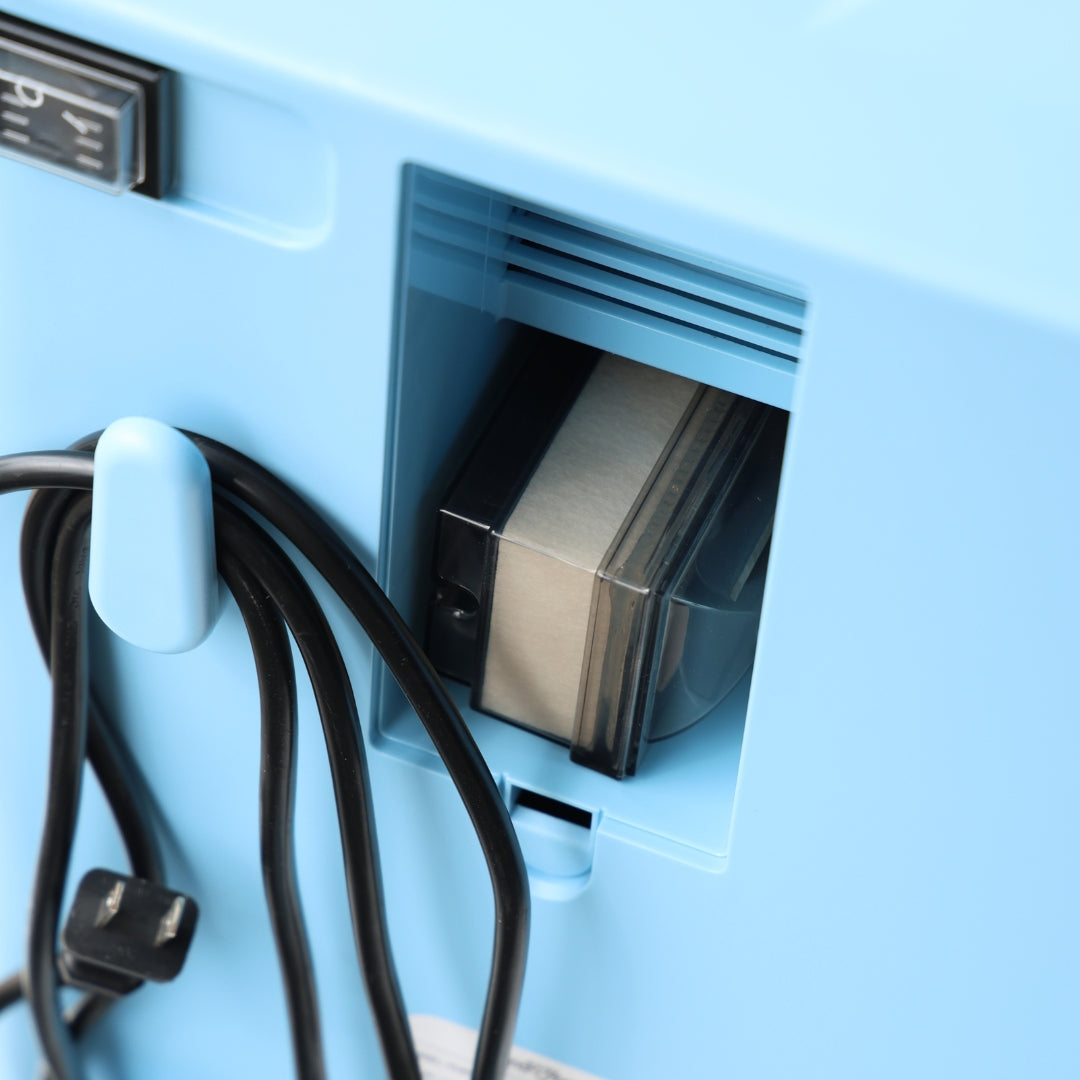 Blue electrical outlet with a power cord plugged in